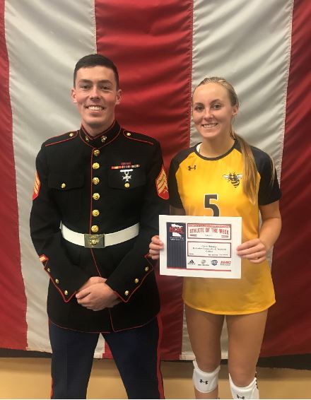 United States Marine Corps Sergeant Peterson presents RCTC standout Carrie Rutledge her Athlete-of-the-Week award.